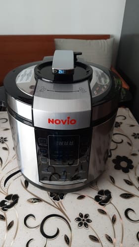 Customer's Novio SteelCook multicooker with a silver metallic finish sitting on a patterned floral tabletop.