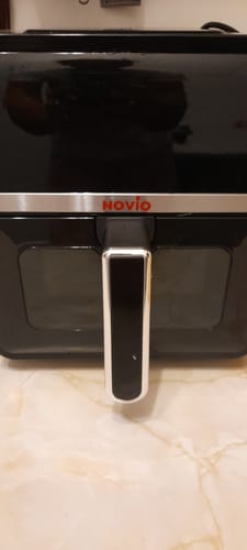 Customer's Novio StonePro air fryer, a sleek black appliance with a silver handle sitting on a marble countertop.