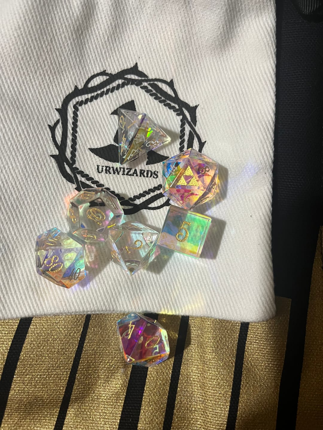 Customer photo review of URWizards D&D Dichroic Prism Glass Gemstone Engraved Dice Set Triforce