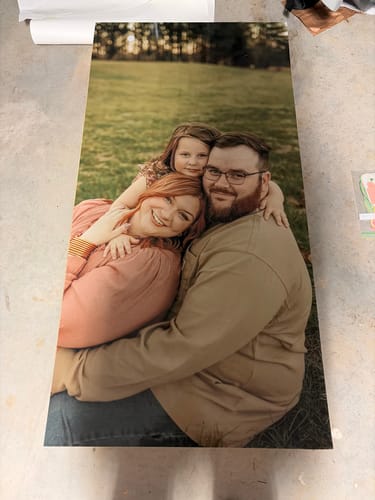 Customer's Custom Cornhole Board Wrap with a family photo printed on the vinyl surface