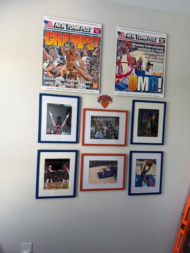 Customer's New York Post Knicks metal prints displayed on a wall with six framed photographs.