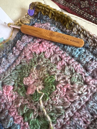 Customer's bamboo Crochetpark hook in use, crocheting a multi-colored yarn square
