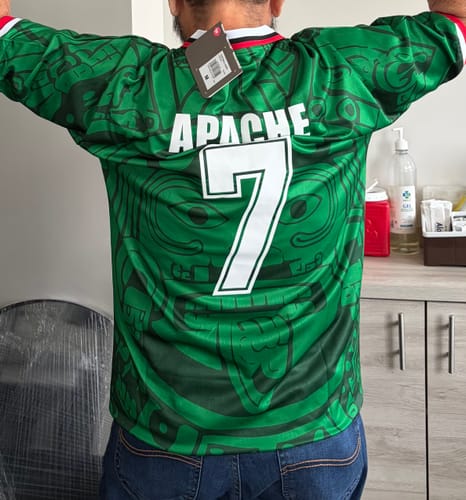 Customer's México Local 1998 jersey with Apache 7 printed on back, worn, showing green fabric and intricate patterns.