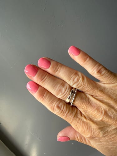 Customer's Whirlwind Holy Gels nails in a bright pink color on a hand after 6 days of wear.