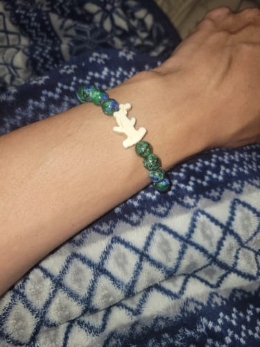 Customer's Shark Week Bracelet with blue and green mottled beads and a light-colored hammerhead charm worn on a wrist.