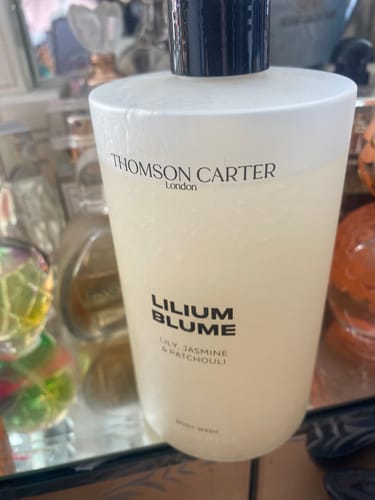Customer's Lilium Blume body wash bottle, clear gel formula in a tall pump bottle on a bathroom surface.