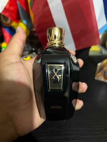 Customer's Xerjoff Opera perfume bottle in black held in a hand