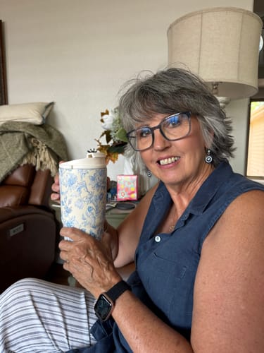 Customer's Blue Floral To-Go Buddy cup held by a person in a home setting.