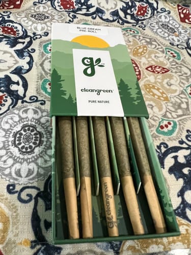 Customer's box of five pre-roll joints from the Cleangreen collection, displayed on a patterned surface.