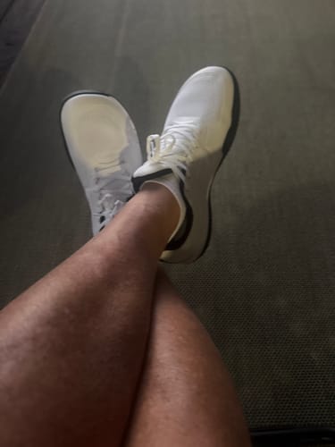 Customer's feet wearing white athletic shoes with comfortable Extra Comfort Support Insoles.