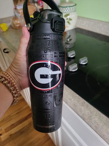 Customer's black Bottle Buddy 24oz Georgia Bulldogs bottle with a red and white team logo held in a hand.