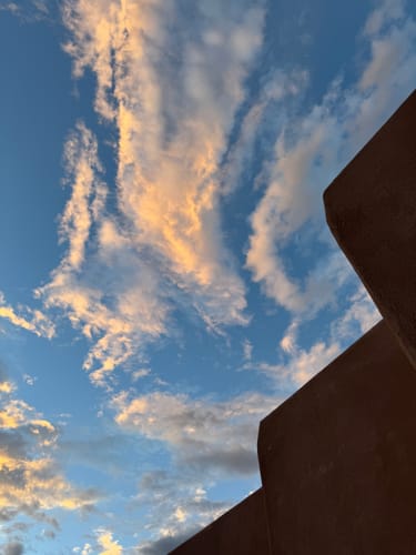 Reviewer's view of a sunset sky through the structure of the Instinct Basket.