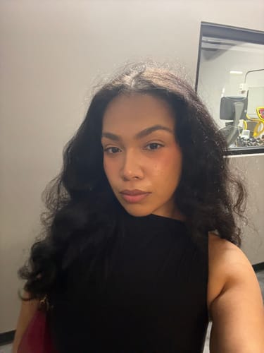 Reviewer's close-up selfie wearing the black Naked Sleeveless Capri Jumpsuit.