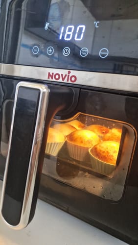 Customer's Novio StonePro air fryer displaying 180 degrees Celsius on the digital panel with muffins baking inside