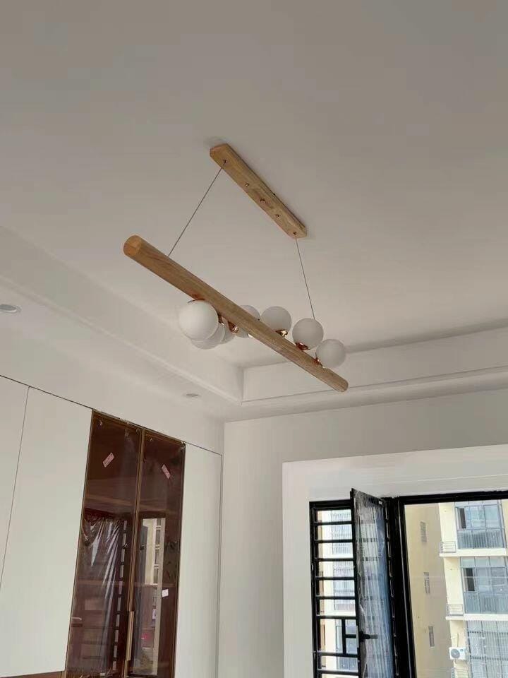 Customer photo review of Linear Wood Pendant Light, Walnut Bar, Opal Glass Globes, G9