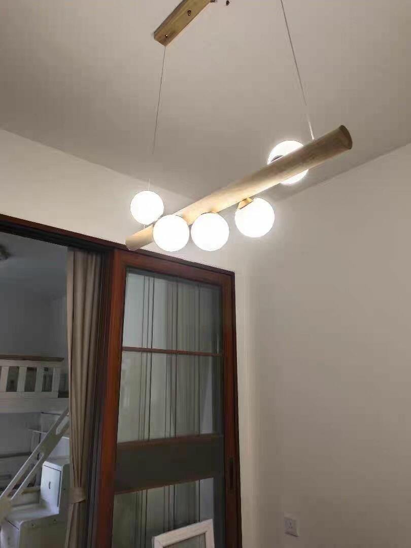 Customer photo review of Linear Wood Pendant Light, Walnut Bar, Opal Glass Globes, G9