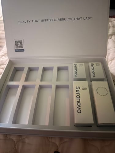 Customer's opened Micro Infusion System box with empty slots and four white product containers inside.