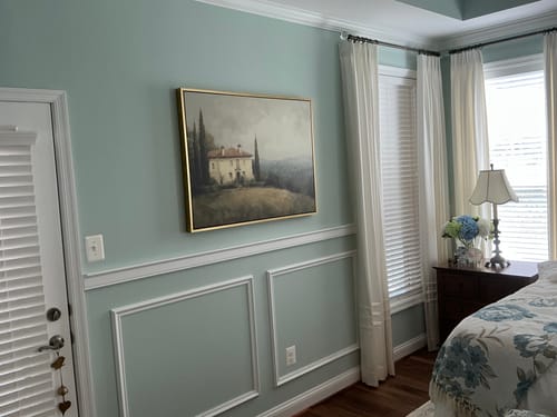 Customer's Country Villa canvas art hanging on a light blue wall, accented by white wainscoting and curtains.