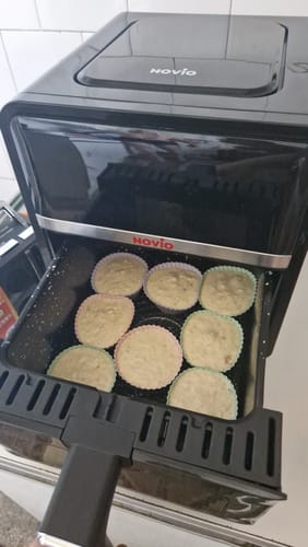 Customer's Novio StonePro air fryer with the open basket containing several muffins in paper liners
