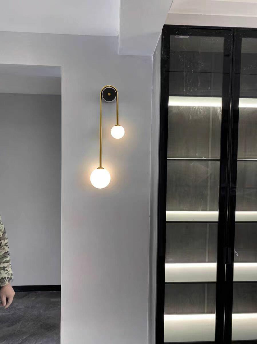 Customer photo review of Brass Arc Wall Light, Curved Arm, Two White Glass Shades, G9
