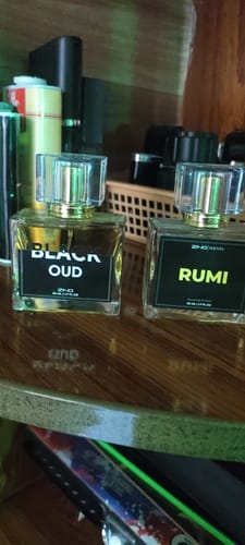 Customer's Royal Oud Collection bottles of Black Oud and Rumi sitting on a wooden surface.