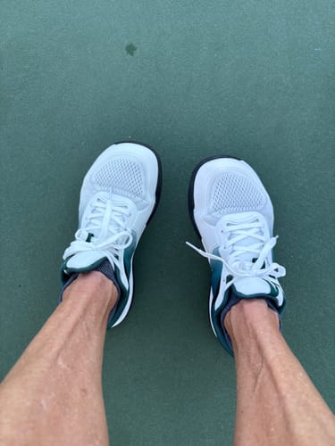 Customer's CUURT Muuv shoes featuring a wide toe box, shown from above on a court surface.