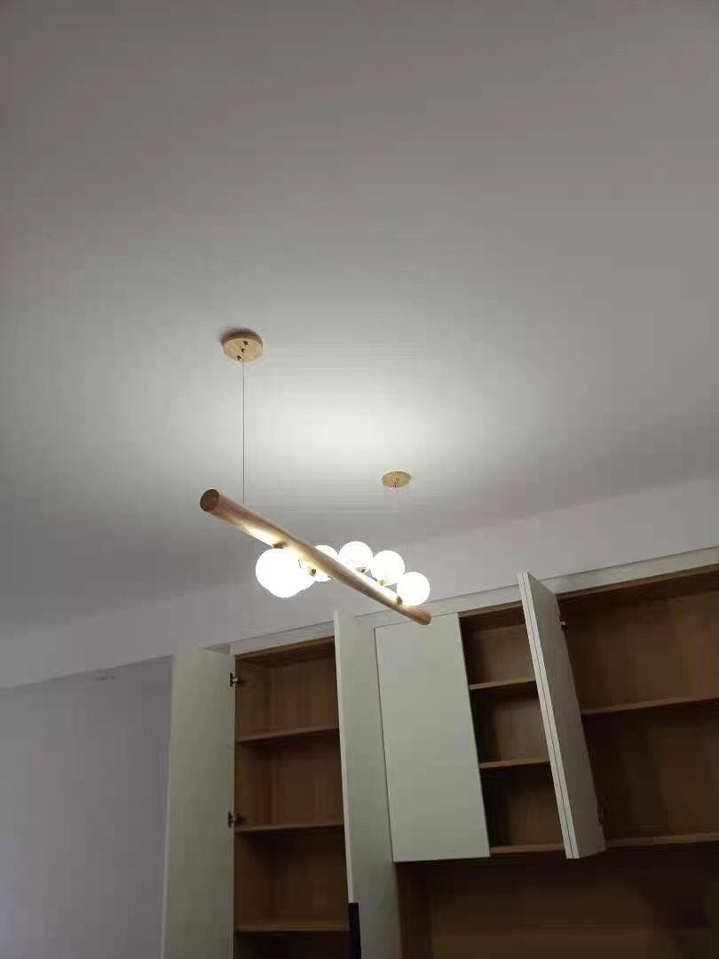 Customer photo review of Linear Wood Pendant Light, Walnut Bar, Opal Glass Globes, G9