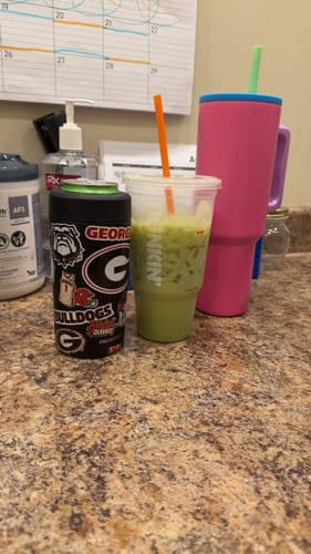 Customer's Georgia Bulldogs Universal Buddy can cooler sitting on a counter next to a plastic cup.
