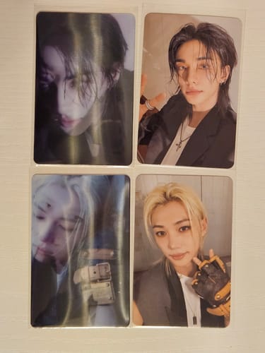 Customer's Stray Kids photocards and lenticular cards showing two different members from the FANS ALBUM collection.