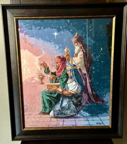 Customer's Custom Paint By Numbers portrait of three robed figures, framed and mounted on a wall.
