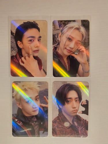 Customer's four Stray Kids Makestar hologram photocards displayed on a flat surface, showing various band members.