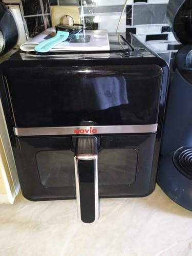 Customer's Novio StonePro air fryer sitting on a kitchen counter with an instruction manual on top.