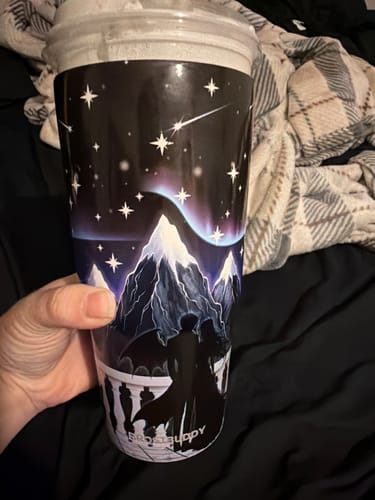 Customer's Nightfall To-Go Buddy tumbler held in hand, showing the mountain scene graphic.