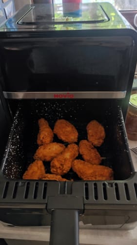 Customer's Novio StonePro air fryer with the open basket showing golden brown cooked food pieces.