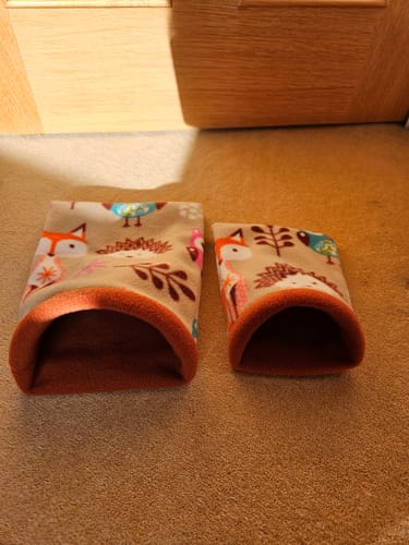 Customer's two handmade polar fleece tunnels featuring animal patterns, used for hedgehog beds.