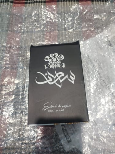 Customer's Sultan perfume box with black label and white crest logo on bubble wrap