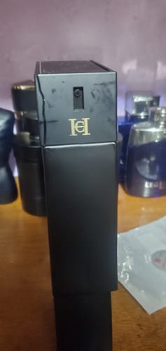Customer's black Carolina Herrera BAD BOY LE PARFUM bottle showing a visible scratch on the top atomizer casing.