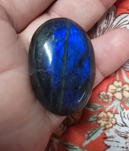 Customer's VIP Crystal Club Labradorite moonstone in hand, showing blue metallic sparkle.
