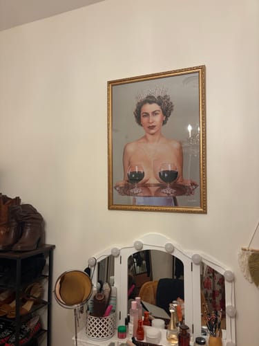 Customer's Majestic artwork in a gold frame, hanging on a wall above a vanity table.