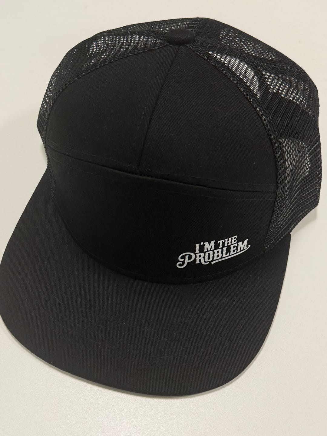 Customer photo review of I'm The Problem Trucker Hat
