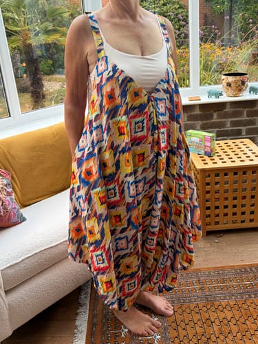 Customer's Diamond Dreams Viscose Challis Fabric sewn into a flowy, abstract-patterned dress worn in a room.
