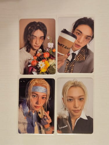 Customer's four Stray Kids THIS & THAT official photocards featuring members with flowers, coffee, and casual clothing.
