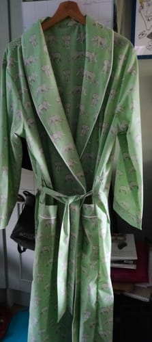 Reviewer's handmade robe in Elephant Family Polycotton Fabric with cream piping hanging on a hanger.