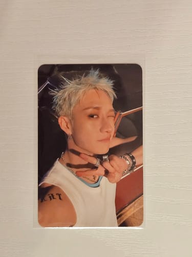 Customer's Stray Kids THIS & THAT photocard featuring a person with bleached hair, winking and flashing a peace sign.