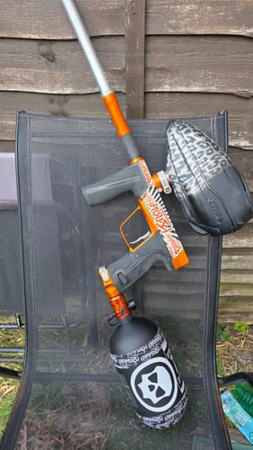 Reviewer's Powerhouse Counterpunch Regulator attached to a paintball marker, sitting on a folding chair