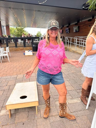Reviewer wearing Judy Blue high-waist denim shorts with studding details at an outdoor event.