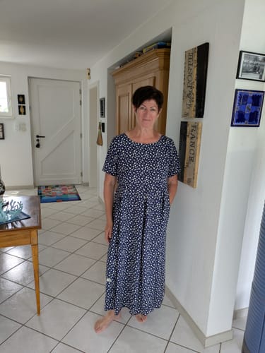 Customer's Louise robe in a blue floral print worn by a person, showing the comfortable fit.