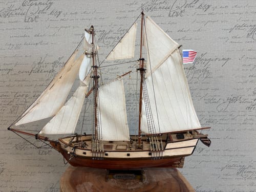 Customer's completed Maqueta Barco Albatros wooden ship model displayed with white sails and an American flag.