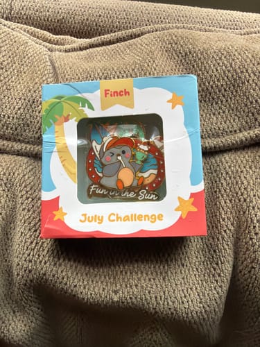 Customer's Fun in the Sun Pin in its colorful, branded July Challenge packaging box.