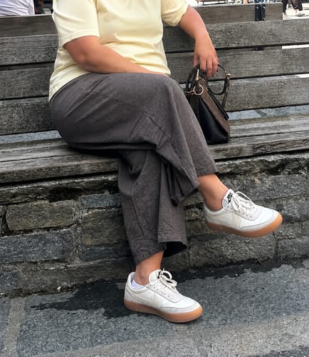 Reviewer's Plus Size Women Spring Plaid Wide-leg Cotton Linen Pants worn on a bench, showing a relaxed fit.